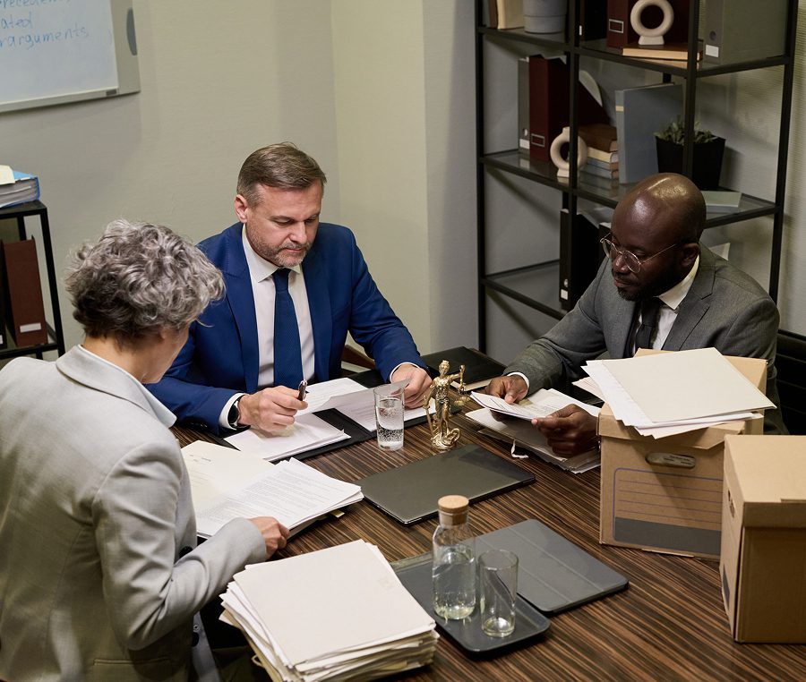 Business meeting with documents and laptops