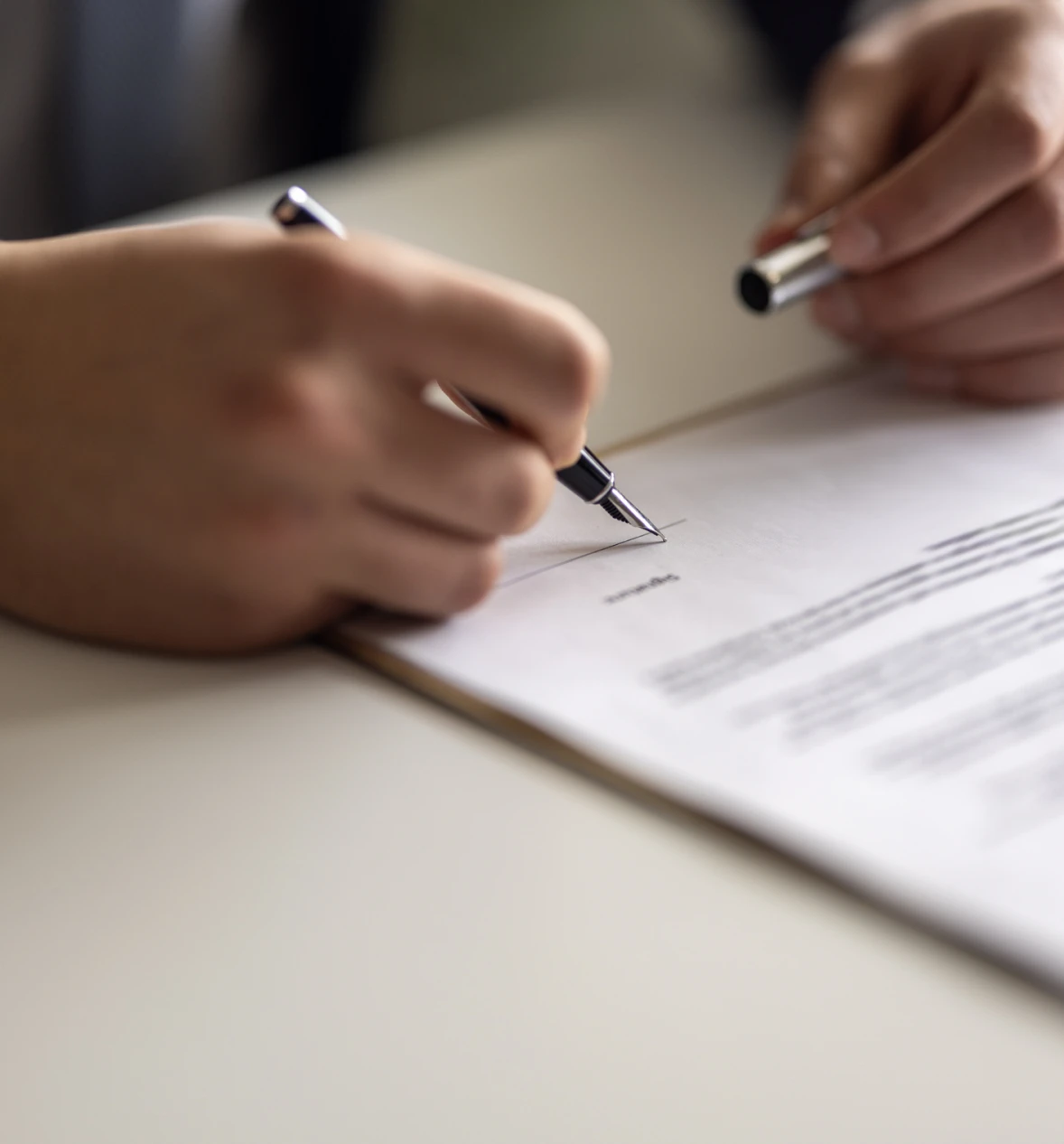 Close-up of contract being signed