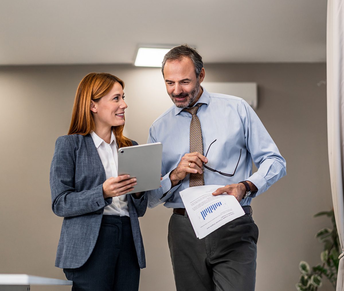 Business colleagues discussing work with tablet